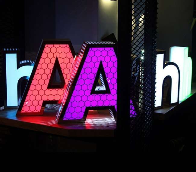 Illuminated storefront signage glowing at dusk